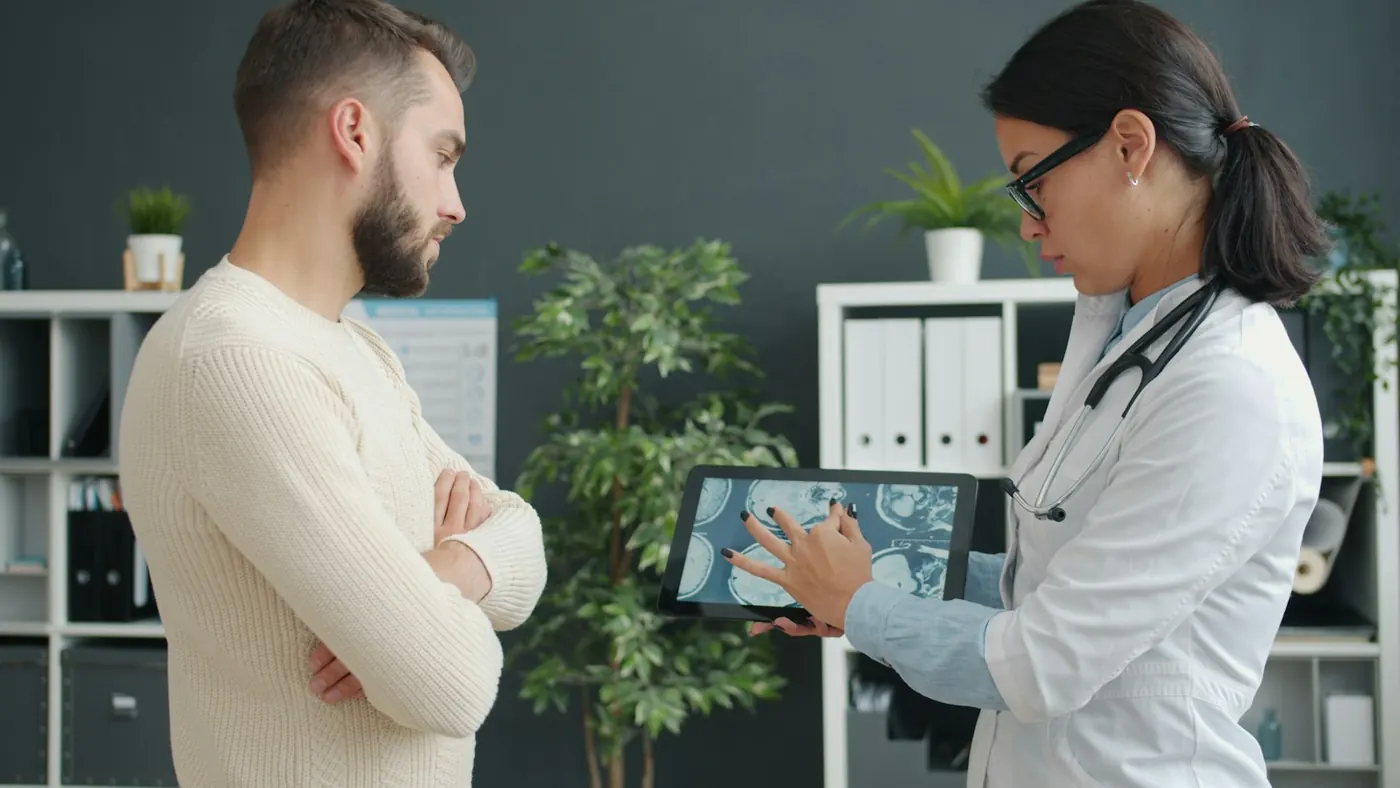 A doctor showing a patient a tablet