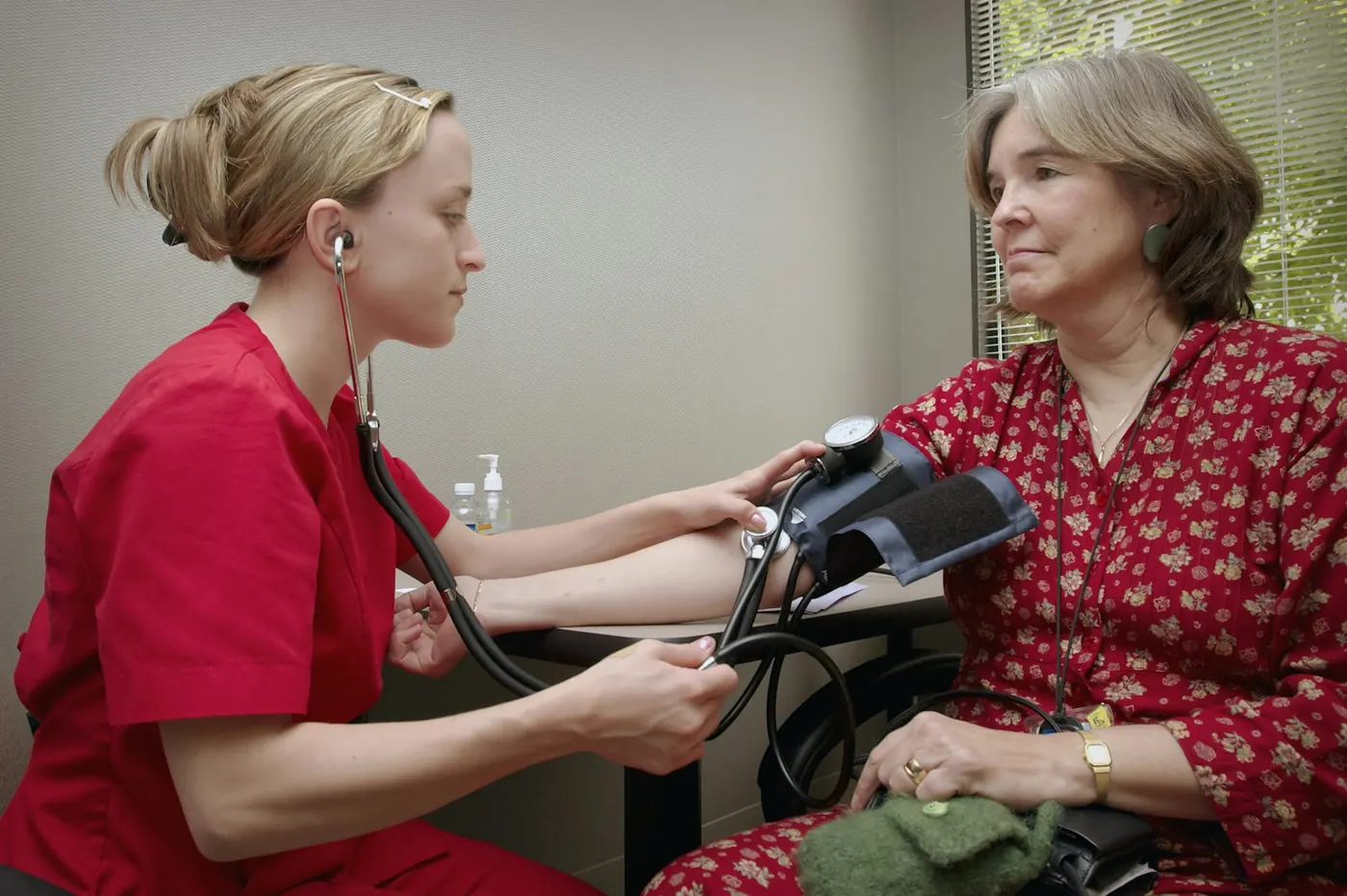 A nurse checking a patient's blood pressure